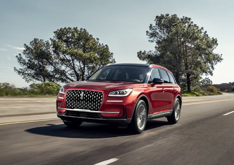 A 2023 Lincoln Corsair® SUV is shown being driven on a country road. | Eby Lincoln in Goshen IN
