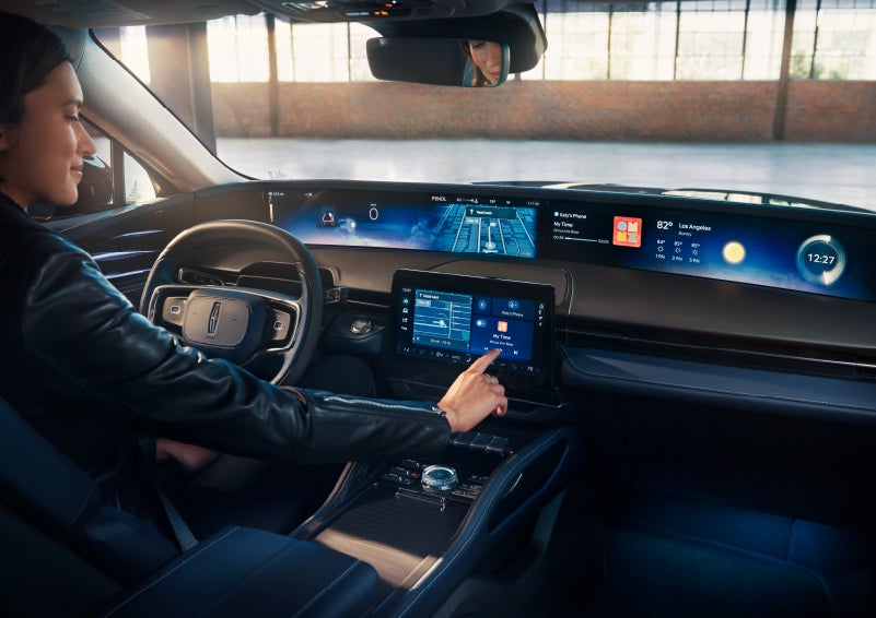 The driver of a 2024 Lincoln Nautilus® SUV interacts with the center touchscreen. | Eby Lincoln in Goshen IN
